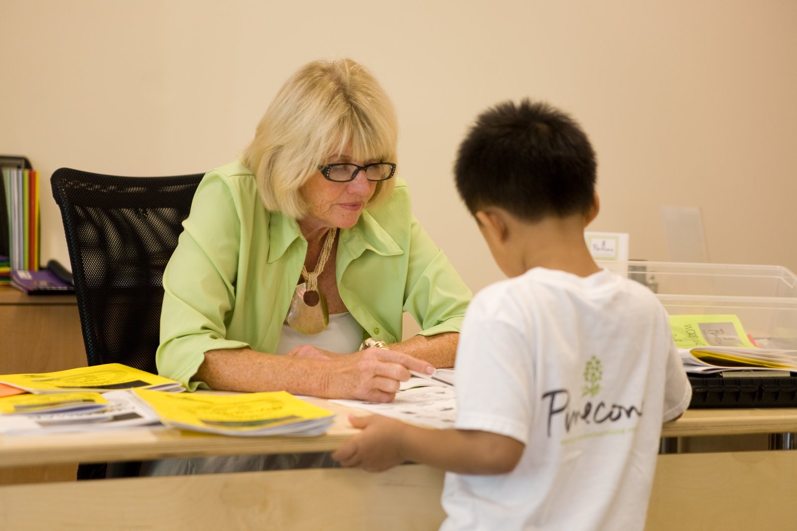 Vivian Hobbs, founder of Pinecone Active Learning, working one-on-one with a young writer at the Evergreen San Jose learning center